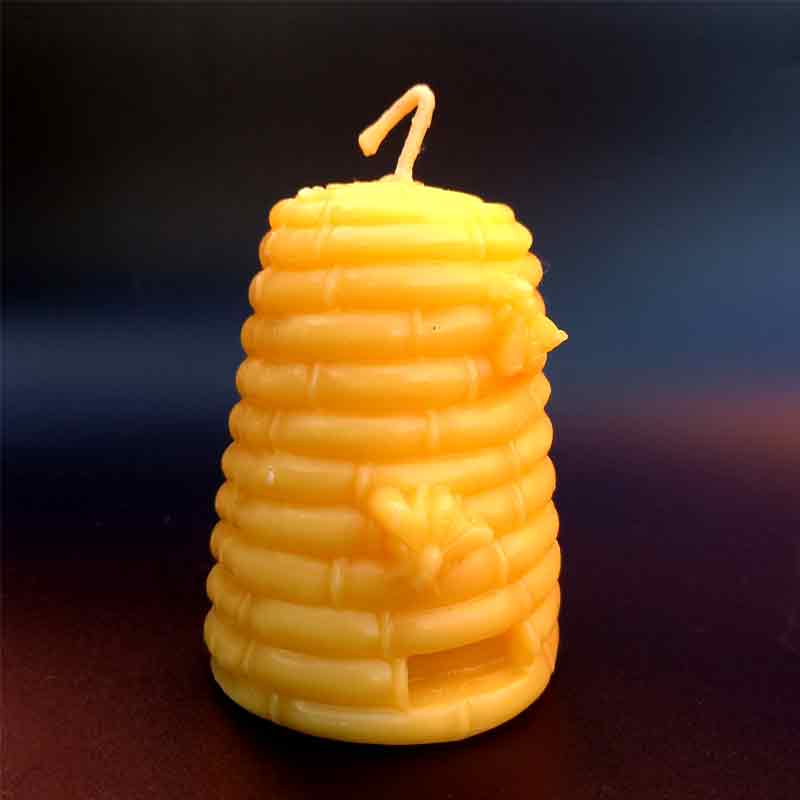 100% beeswax candle in the shape of a beehive