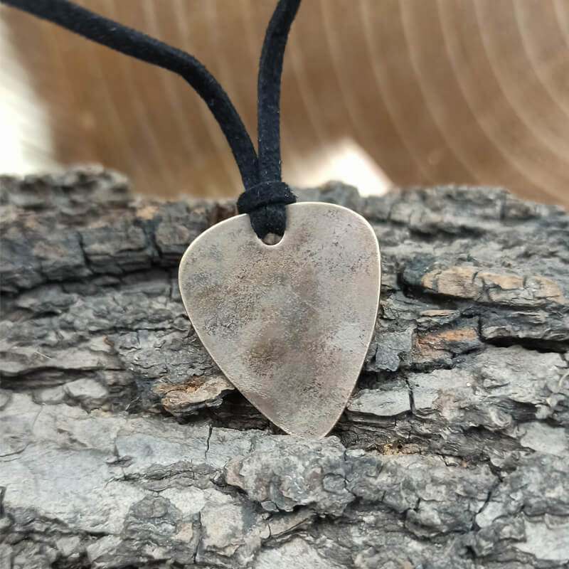Made from a real bronze cymbal, this pick necklace is the ultimate gift for a guitar-playing music lover. - back view