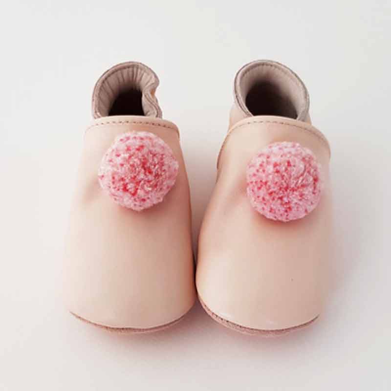 Soft pale pink leather slippers with a pink pompom