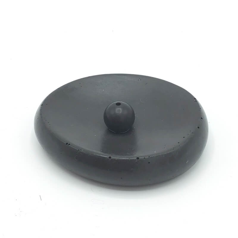 A neat little black concrete incense holder. 