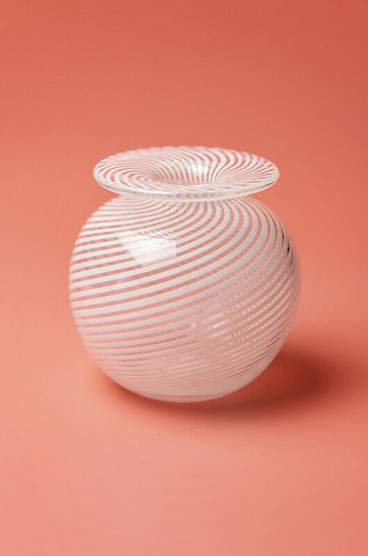 A small heavy round vase with white filigrana cane decoration, which was invented by Venetian glassblowers on the island of Murano in the early 16th century. This glass is made in the only artisanal glassblowing studio in Northern Ireland.