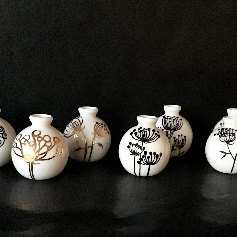 A selection of tiny fine porcelain vases with glazed flower painting.  